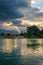 Cloudscape and sunbeams on lake