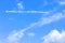 Cloudscape with trail from the plane, blue sky with white clouds cloudscape. Beautiful nature background backdrop sky with cumulus