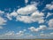 Cloudy aerial landscape with white clouds on a blue sky background. Aerial view from drone.