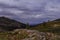 Cloudy alpine landscape with mountains and rocks in Altai