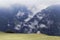 Cloudy alpine landscape with a small chapel