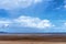 Cloudy Blue Sky Over A Tidal Beach