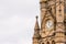 Cloudy day view gothic architecture details with clock in england