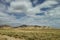 Cloudy grassland and mountain