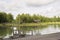 Cloudy lake landscape with wooden house