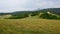 Cloudy landscape with hills, forests and meadows above town of Slovenska Lupca