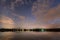 Cloudy night sky with milky way over riegsee bavaria