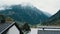 Cloudy rainy Alps mountains view from wooden balcony