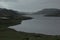 Cloudy rainy dreary landscape with views of the lake and mountains.