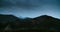 Cloudy and rainy landscape shot in timelapse with clouds moving on mountain peak
