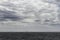 Cloudy seascape with a ships on the horizon