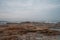 Cloudy seaside, rocks on the beach