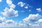 Cloudy serenity blue sky background with gentle and wispy clouds