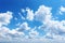 Cloudy serenity blue sky background with gentle and wispy clouds