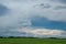Cloudy skies above canola fields, Saskatchewan, Canada.