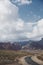 Cloudy sky above road winding into mountains