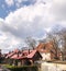 Cloudy sky bare trees and roof tops Spring time Baltic Landscapes