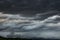 Cloudy sky, dark clouds, close storm over mountain range