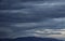 Cloudy sky, dark clouds, close storm over mountain range