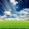 Cloudy sky with green grass meadow