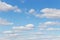 Cloudy sky. Light blue sky with puffy cumulus clouds, heavenly landscape. Background wallpaper backdrop texture. summer cloudy day