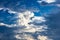 Cloudy sky; light and dark clouds, blue sky. Variety of different cloud types.