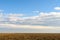 Cloudy Sky Over Harvested Land