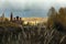 Cloudy sky over Orthodox monastery and the autumn forest