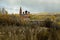 Cloudy sky over Orthodox monastery and the autumn forest