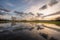 Cloudy sky reflecting in the water in flooded meadow