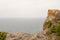 Cloudy sky, sea and a piece of rock