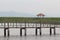 Cloudy Sky, Shelter and wooden bridge on small lake among green nature grass backgrounds in early of summer season