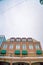 Cloudy sky and string lights over a building with brick wall and snowy balcony