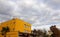 Cloudy sky and yellow buildings