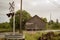 Cloudy summer day with road/highway barn and railroad crossing