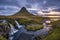 Cloudy sunrise at the iconic Kirkjufellsfoss waterfall in the The Snaefellsnes Peninsula, West Iceland