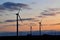 Cloudy sunset in dusk with windmills silhouettes and cloudes