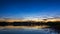 Cloudy sunset on a quiet summer solstice evening at lake Zirnajai in Lithuania