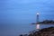 Cloudy twilight seascape with lighthouse