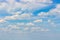 Cloudy weather in summer, clear blue sky with lush cumulus clouds, cloudscape background wallpaper backdrop nature. Natural sky