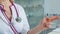 Clouse up of Medical Staff Hospital woman doctor gestures with his hand and counts with her fingers in the clinic in a