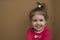 Clouse-up portrait of cheerful little girl on the background of a cardboard box