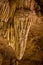 Clouse up of ripples in stalactite of cave stuck to ceiling