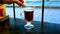 Clouse up view of female pouring capsule milk into coffee cup.