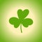Cloverleaf on a green background.Silhouette of the magical plant.Decoration for St. Patrick`s Day,trefoil,Shamrock.Hand drawn.