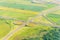 Cloverleaf interchange seen from above. Aerial view of highway road junction in the countryside with trees and cultivated fields.