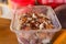 Cloves of garlic are in a plastic bowl prepared for planting in the ground.