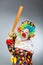 Clown with baseball bat in funny concept