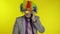 Clown businessman entrepreneur boss talking on mobile phone. Yellow background