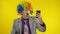 Clown businessman entrepreneur boss in wig making selfies using smartphone